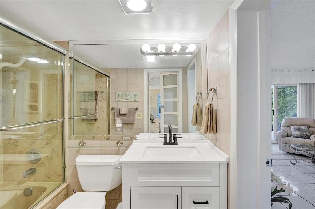 505 North Riverside Drive, Unit 7 Pompano Beach, FL 33062 - Photo 15 of 43 a bathroom with a sink a toilet a mirror and shower