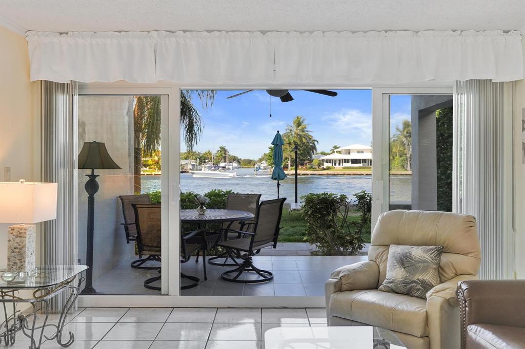 505 North Riverside Drive, Unit 7 Pompano Beach, FL 33062 - Photo 7 of 43 a living room with furniture and a floor to ceiling window