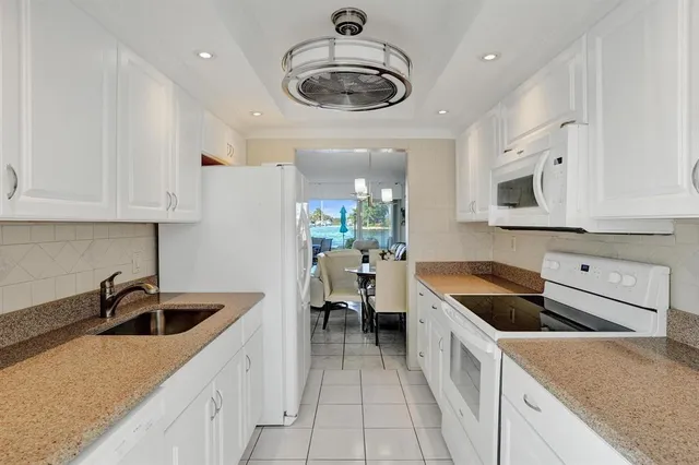 a kitchen with a sink and a refrigerator