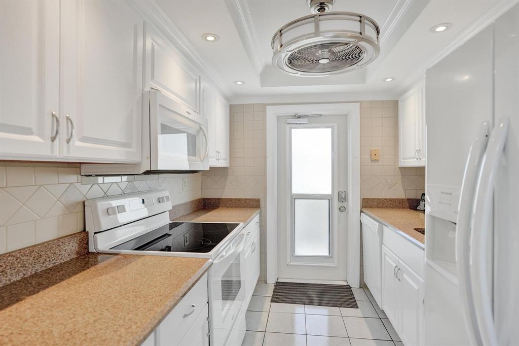 505 North Riverside Drive, Unit 7 Pompano Beach, FL 33062 - Photo 9 of 43 a kitchen with a sink and a refrigerator