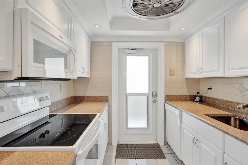 505 North Riverside Drive, Unit 7 Pompano Beach, FL 33062 - Photo 10 of 43 a kitchen with a sink stove and cabinets