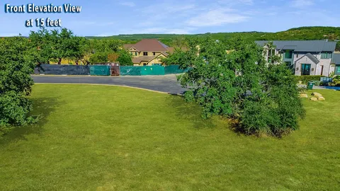a view of a fountain in front of a big yard