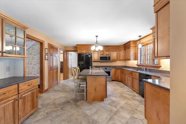 a large kitchen with lots of counter space and windows