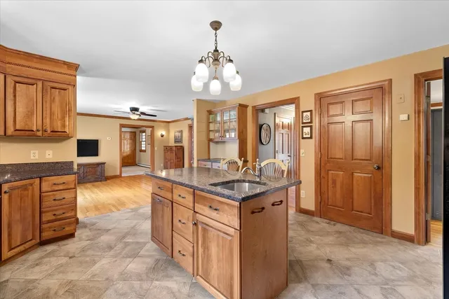 a kitchen with stainless steel appliances granite countertop a sink and cabinets