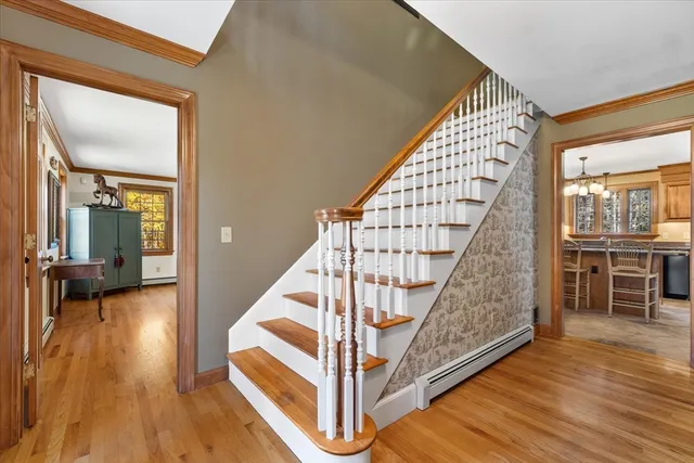 a view of entryway and hall with wooden floor