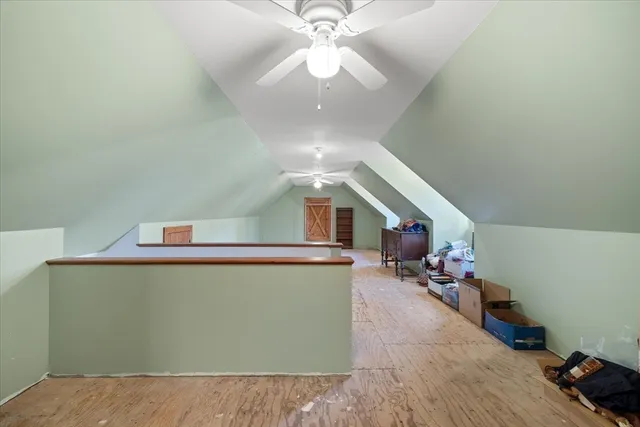 a view of a livingroom with furniture and a ceiling fan
