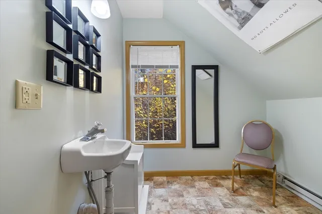 a bathroom with a sink a mirror and a window
