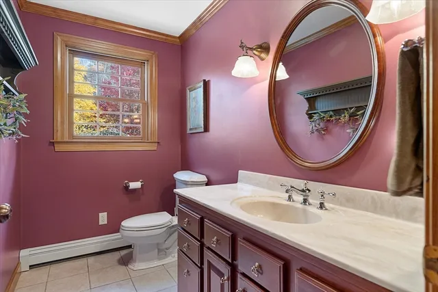 a bathroom with a toilet a sink and mirror