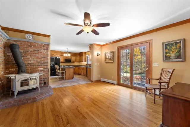 a view of a livingroom with furniture hardwood floor and a ceiling fan