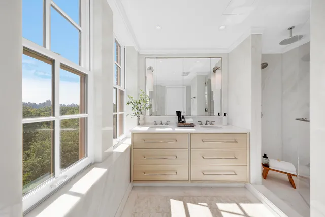 a spacious bathroom with a double vanity sink and a large mirror