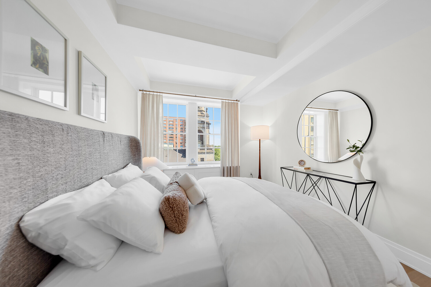 360 Central Park West, Unit 8A/9A Manhattan, NY 10025 - Photo 13 of 17 a bedroom with a bed a mirror and a large window