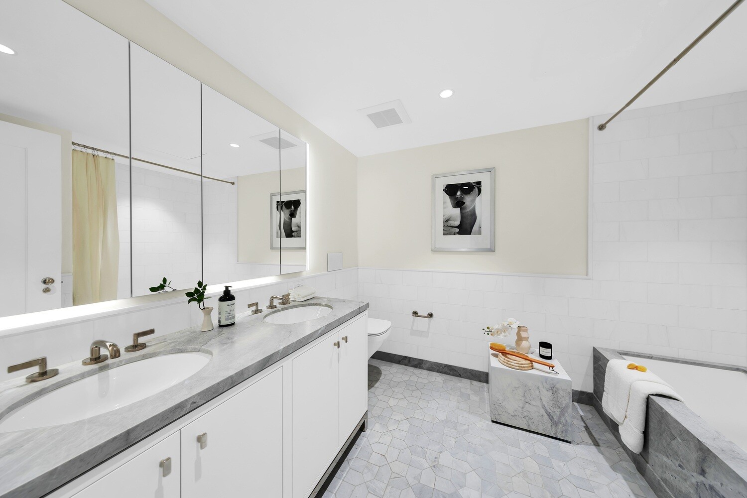 360 Central Park West, Unit 8A/9A Manhattan, NY 10025 - Photo 14 of 17 a bathroom with a double vanity sink a mirror and a bathtub