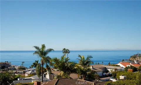 a bathroom with a granite countertop toilet a sink and a mirror