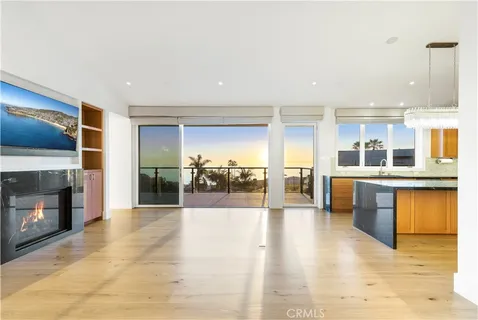 a view of a balcony with dining table and chairs