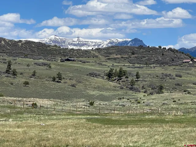 a view of a lake with houses in the back
