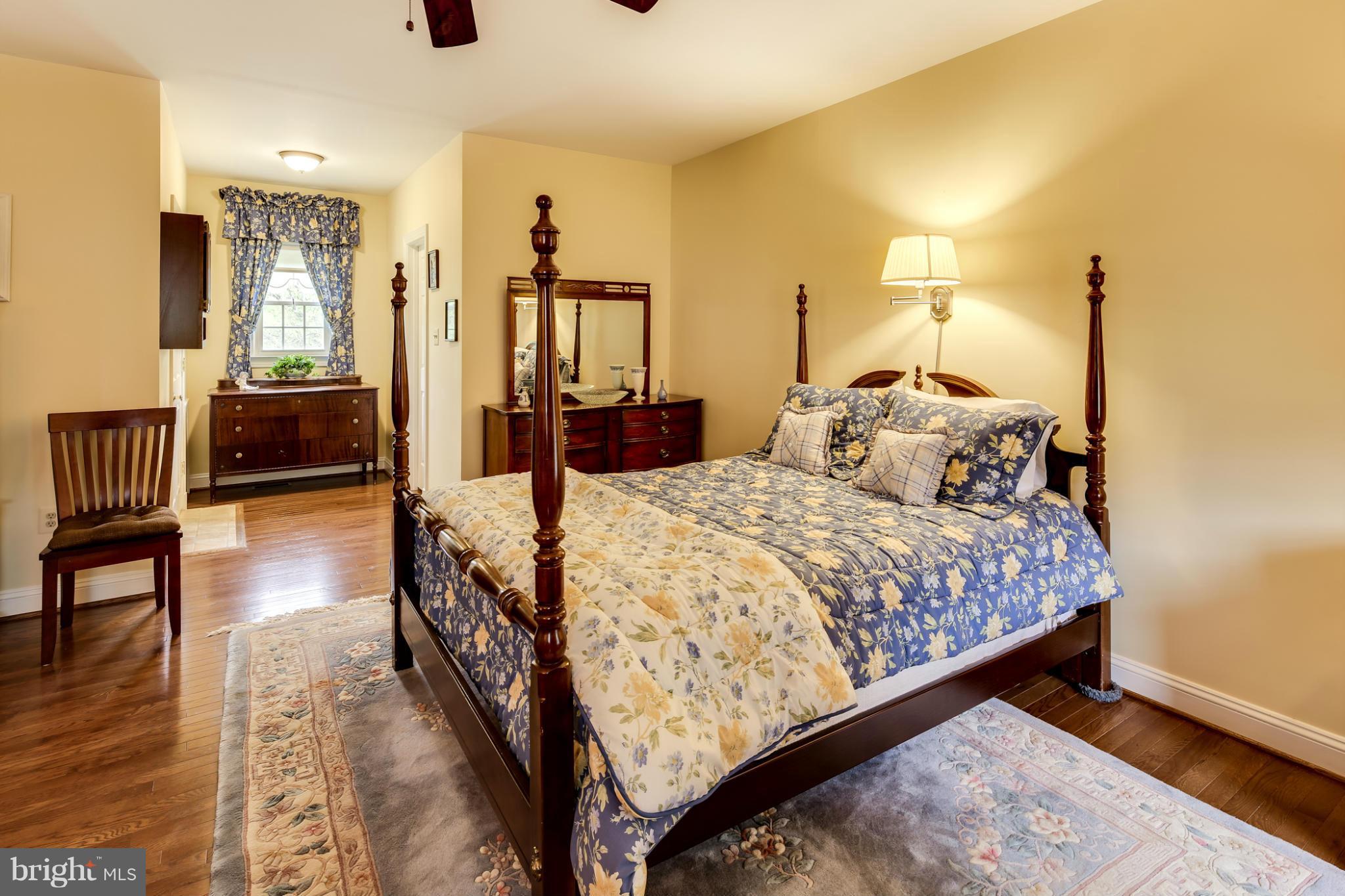 14608 Cutstone Way Silver Spring, MD 20905 - Photo 15 of 30 a bedroom with a large bed and a chandelier