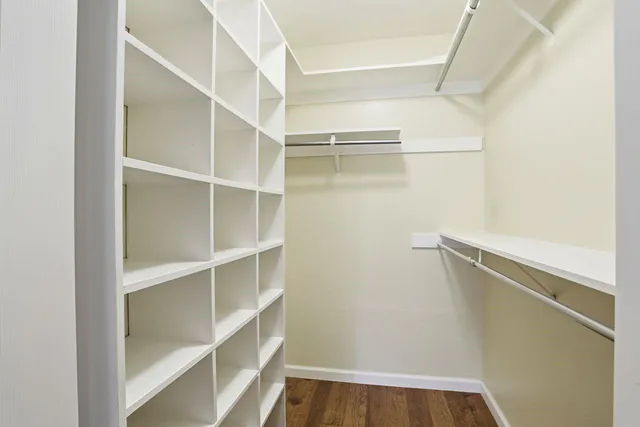 a bathroom with a sink a toilet and a large mirror