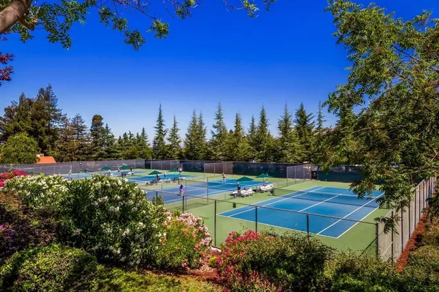 a view of a house with pool and chairs
