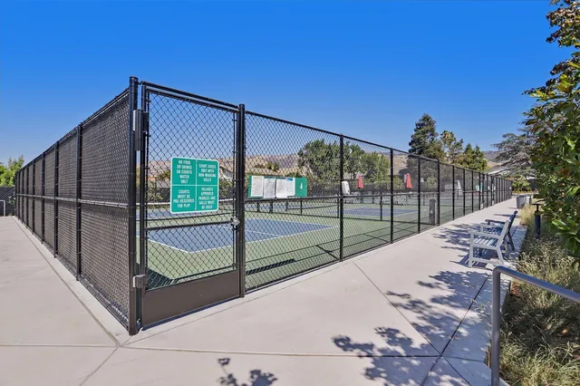 a view of a patio with a table and chairs under an umbrella