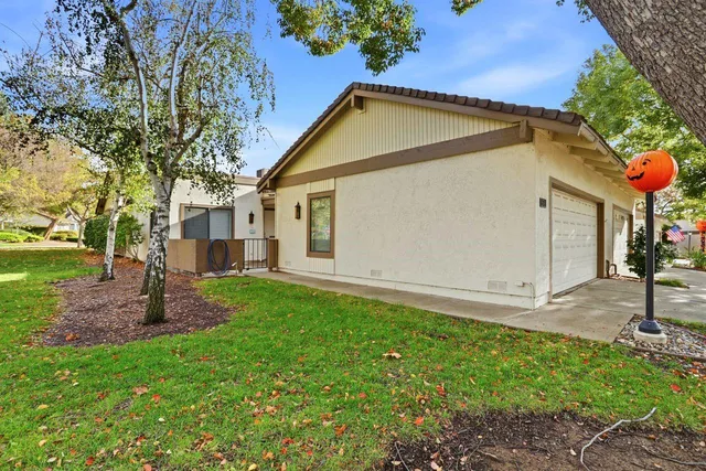 a view of a house with a backyard and sitting area