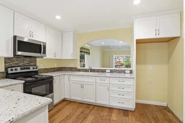 a view of a dining room with furniture and a potted plant