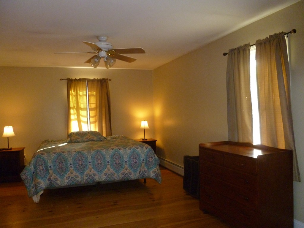 61 O'Neil Road Warren, MA 01092 - Photo 13 of 21 a bedroom with a bed and wooden floor
