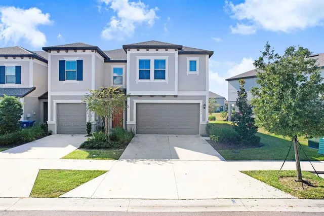 a front view of a house with a yard and garage
