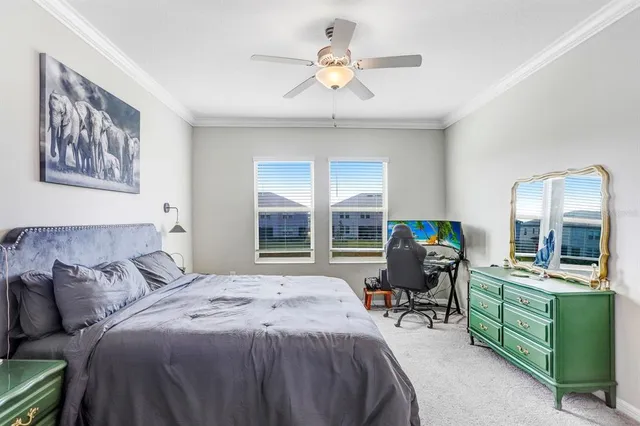 a bedroom with a bed and a large window