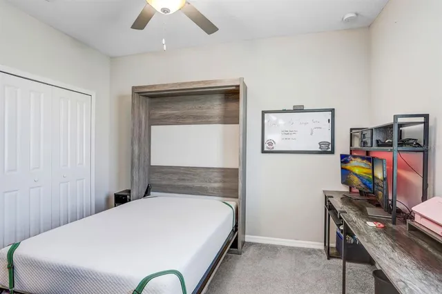 a bed room with a bed and a flat tv screen