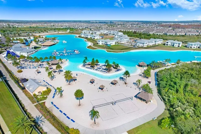 an aerial view of a residential houses with outdoor space and seating
