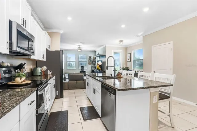 a kitchen with granite countertop lots of counter top space and stainless steel appliances