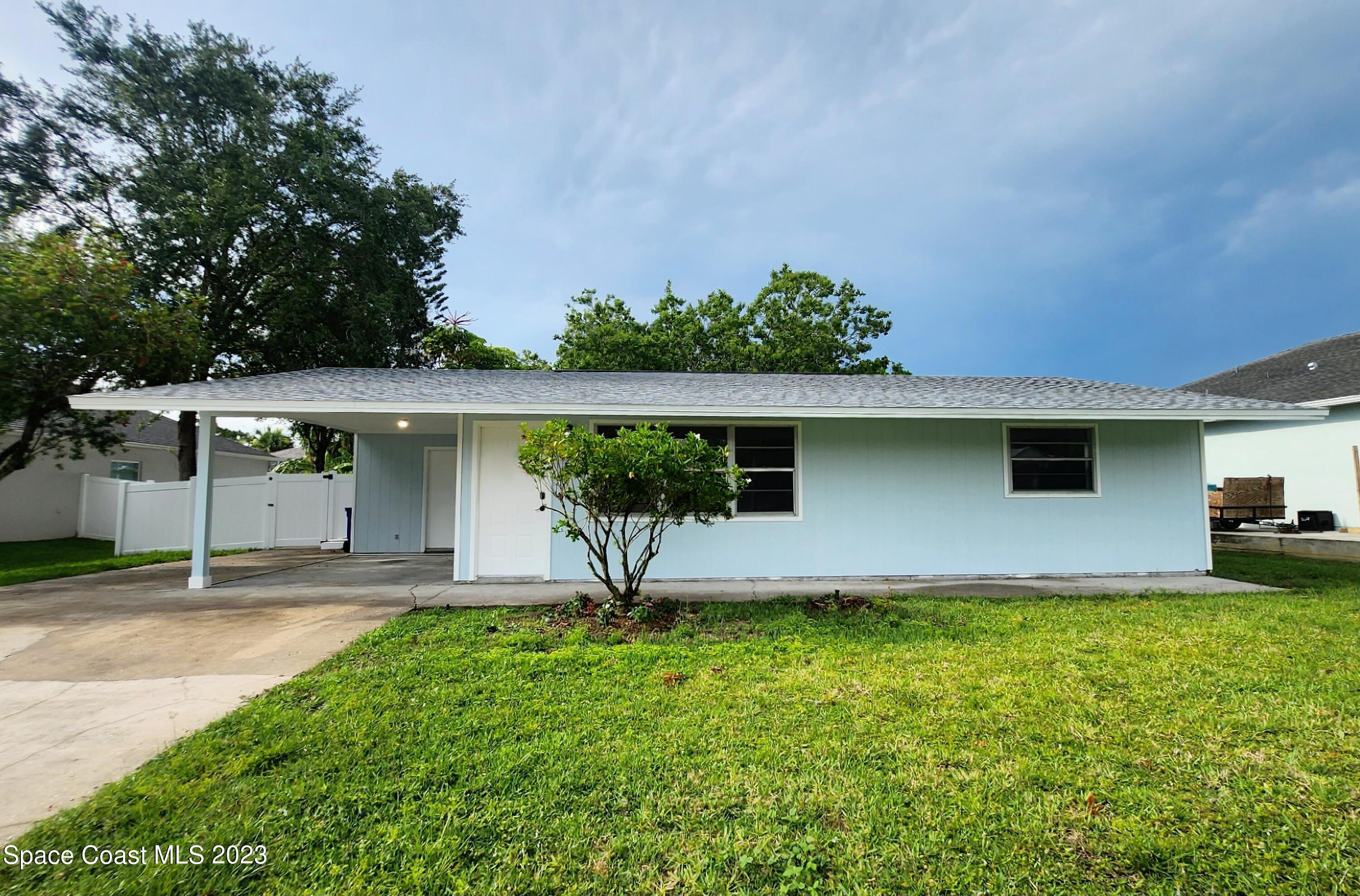 a front view of a house with a yard and a garage