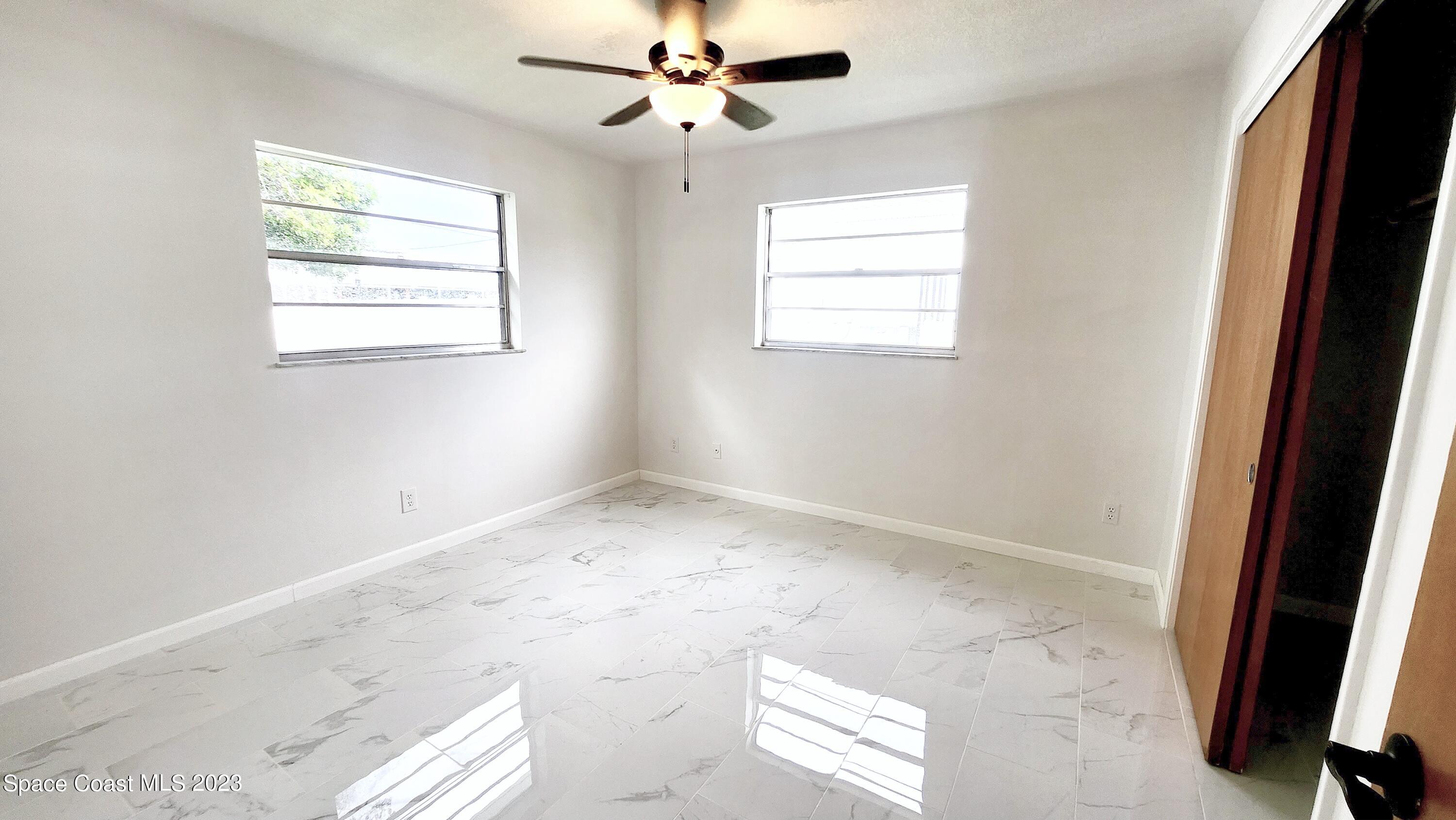 925 Gulfstream Avenue Sebastian, FL 32958 - Photo 11 of 19 an empty room with windows and fan
