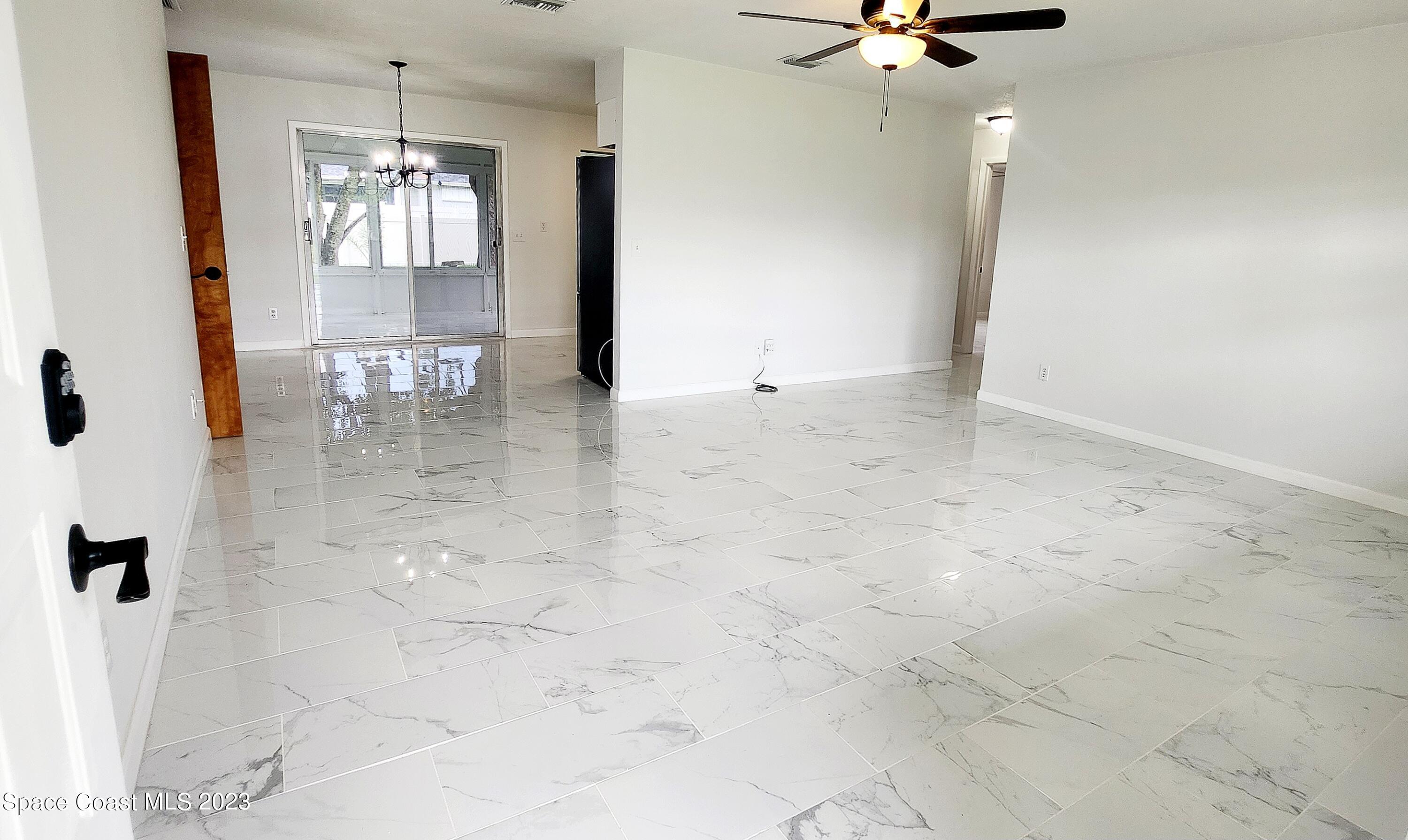 925 Gulfstream Avenue Sebastian, FL 32958 - Photo 3 of 19 a view of a hallway with a chandelier