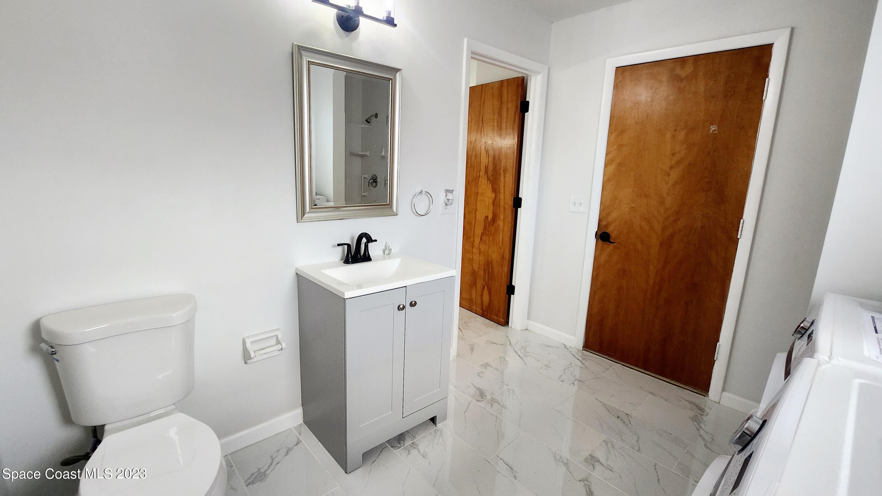 925 Gulfstream Avenue Sebastian, FL 32958 - Photo 7 of 19 a bathroom with a sink and a mirror