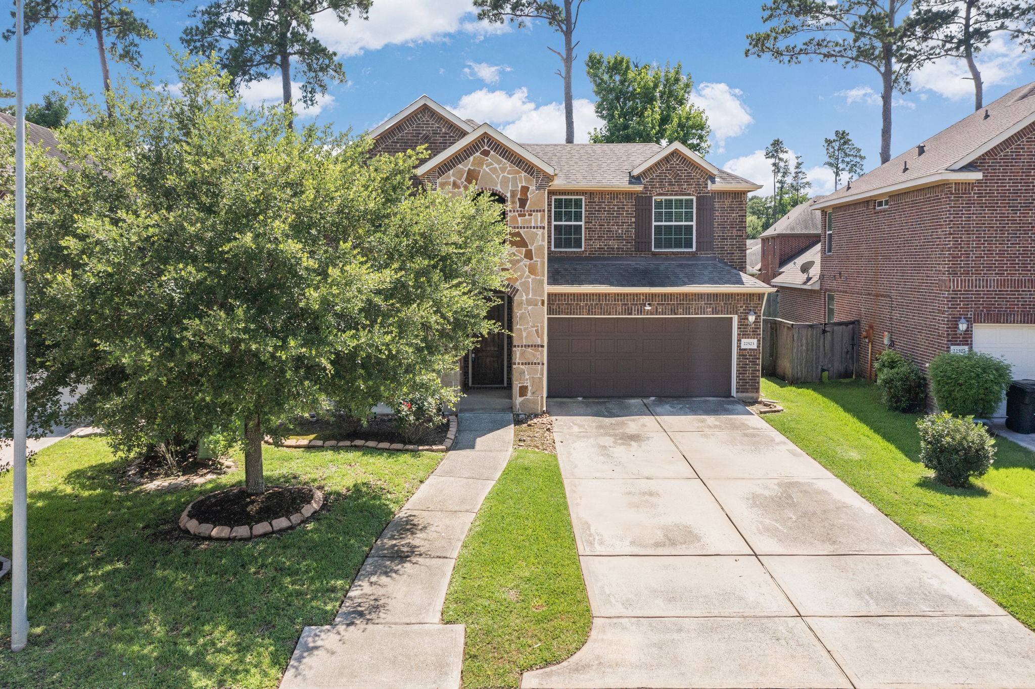 22523 Birch Ridge Meadow Drive Spring, TX 77389 - Photo 37 of 39 a front view of a house with a yard and a garage