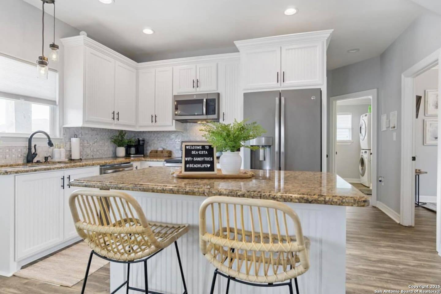 a kitchen with stainless steel appliances granite countertop a kitchen island a stove a table and chairs