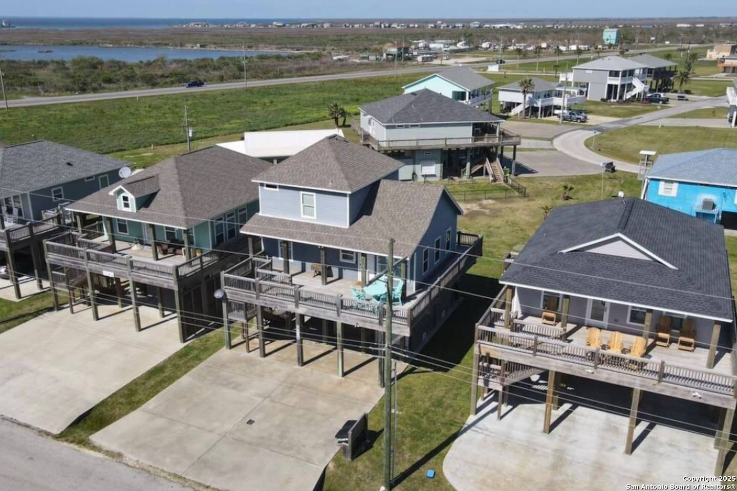972 Surf Road Crystal Beach, TX 77650 - Photo 15 of 18 an aerial view of a house with garden space and mountain view in back