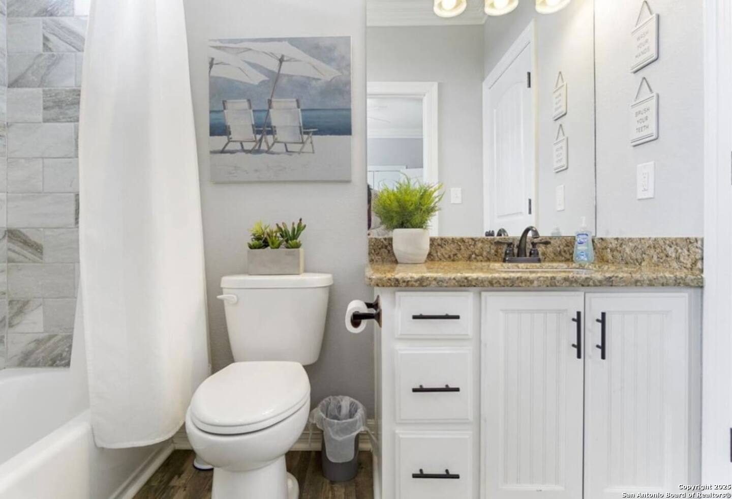 972 Surf Road Crystal Beach, TX 77650 - Photo 8 of 18 a bathroom with a granite countertop toilet sink and mirror
