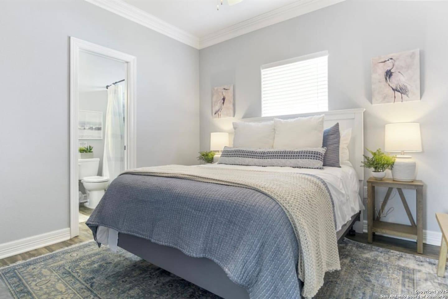 972 Surf Road Crystal Beach, TX 77650 - Photo 9 of 18 a bedroom with a bed and a table