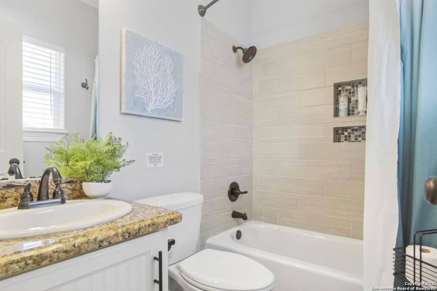 972 Surf Road Crystal Beach, TX 77650 - Photo 10 of 18 a bathroom with a granite countertop sink a toilet and bathtub