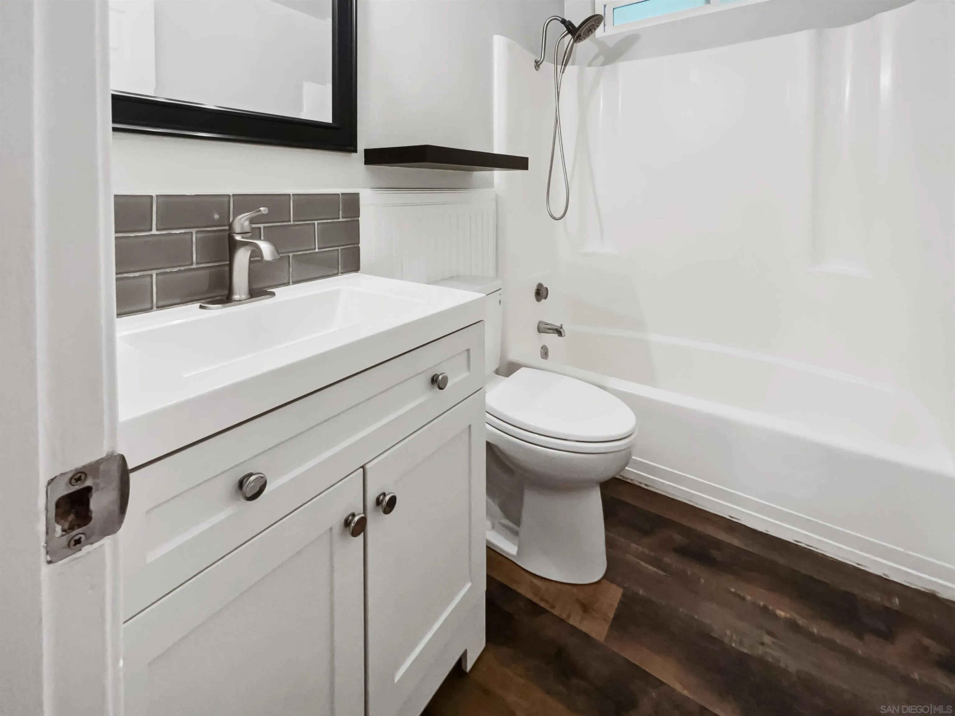 212 South Wisconsin Street Fallbrook, CA 92028 - Photo 12 of 16 a bathroom with a sink toilet and shower