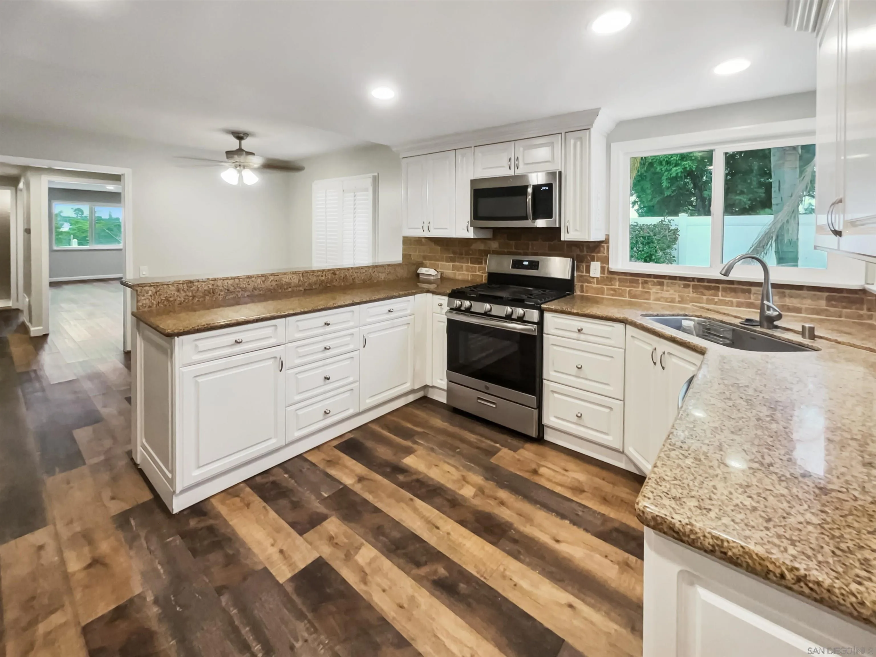 212 South Wisconsin Street Fallbrook, CA 92028 - Photo 6 of 16 a kitchen with granite countertop a sink stainless steel appliances and cabinets