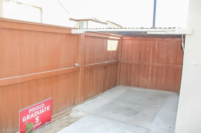 a backyard of a house with potted plants and palm trees