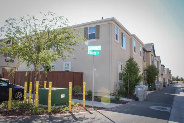 a kitchen with a table chairs microwave and cabinets