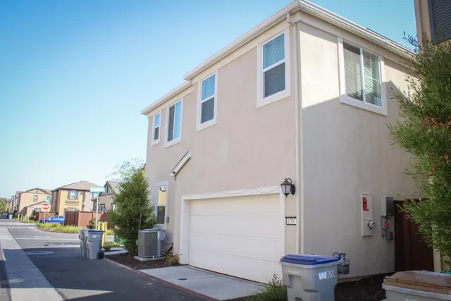 a bathroom with a granite countertop sink and a window