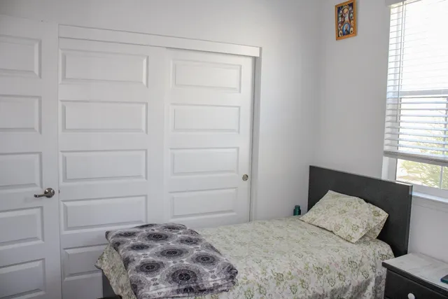 a bedroom with a bed and a window