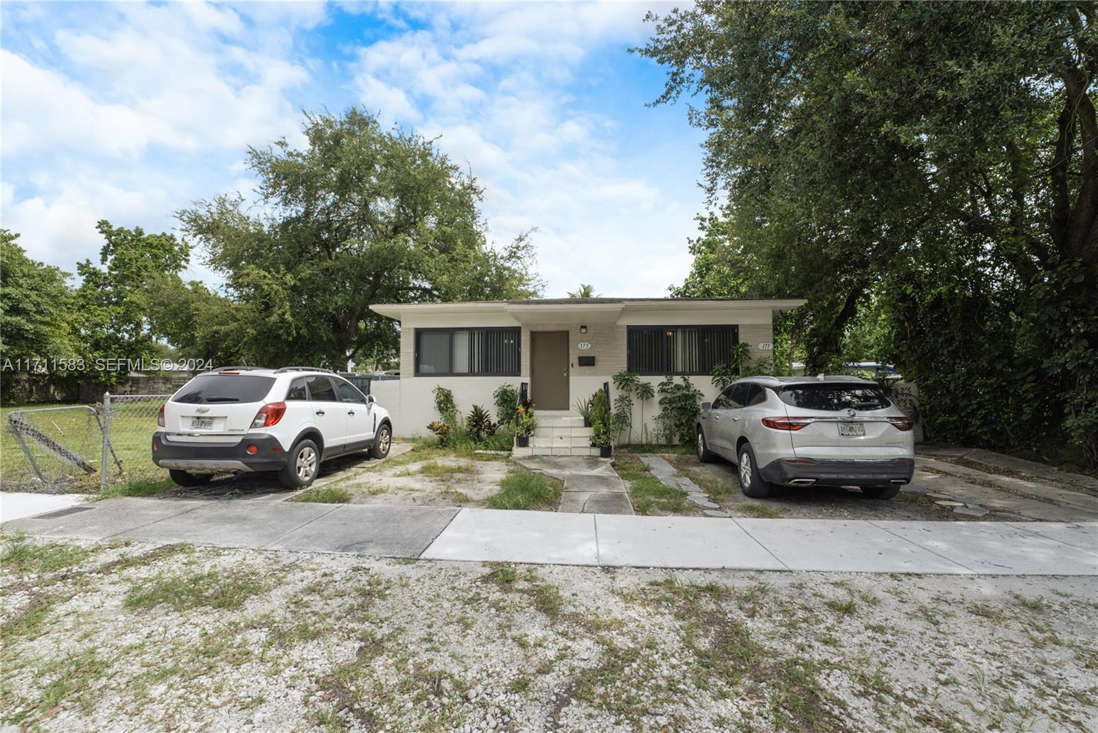175 Northwest 68th Street Miami, FL 33150 - Photo 1 of 31 a white car parked in front of a house