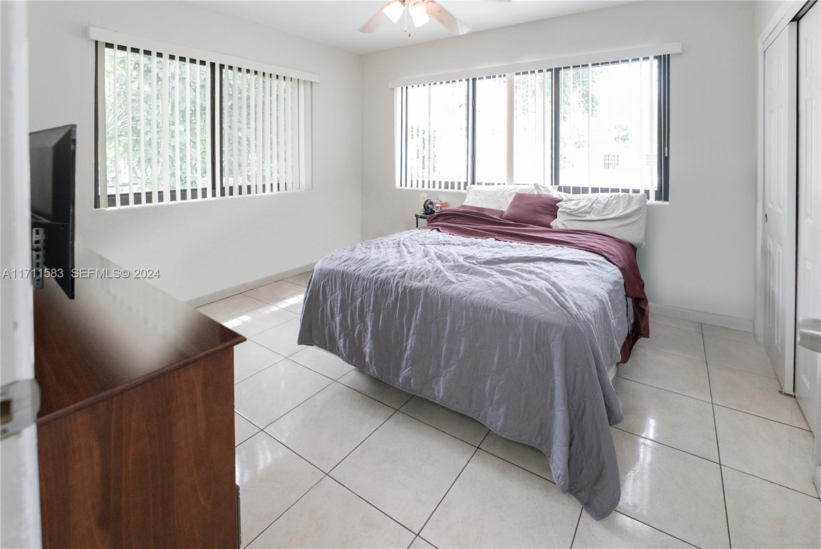 175 Northwest 68th Street Miami, FL 33150 - Photo 11 of 31 a bed sitting in a bedroom next to a window
