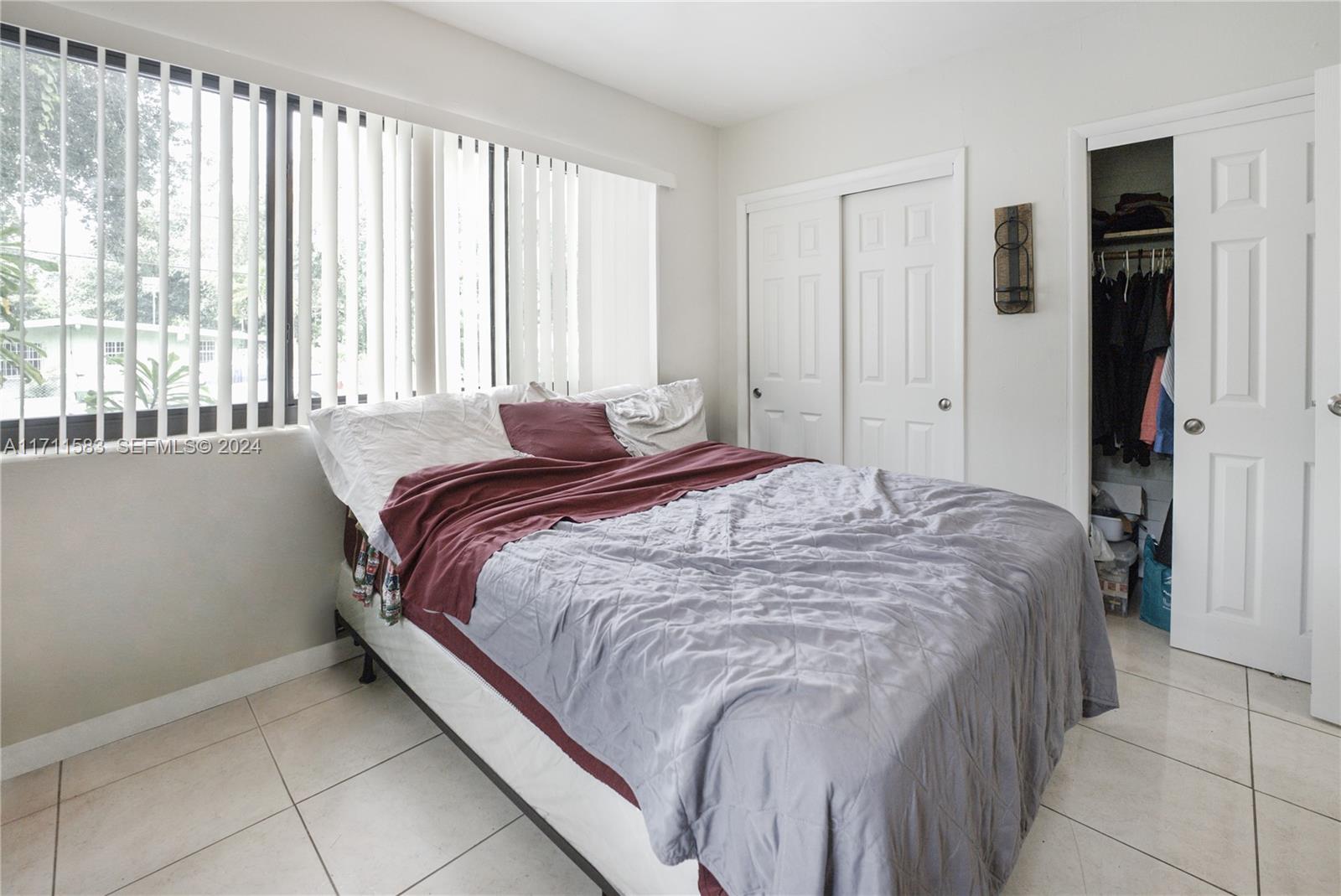 175 Northwest 68th Street Miami, FL 33150 - Photo 12 of 31 a bedroom with a bed and a window